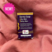 Box of Derma-Soap on a pink fabric background with a 'NEW!' label.