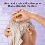 Noughty shampoo being poured onto hand with hair lathered.