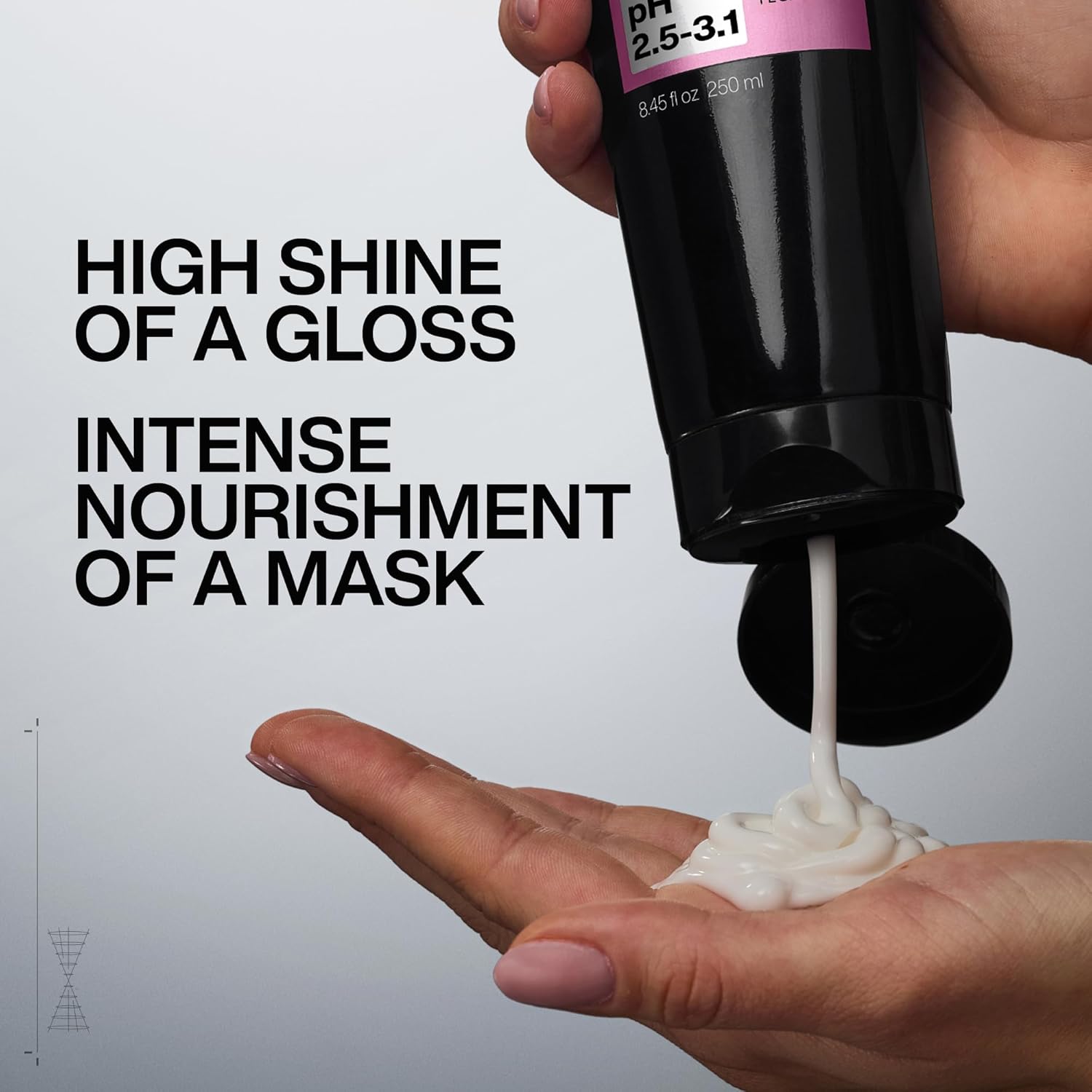 Redken Hair Mask being squeezed from a tube.