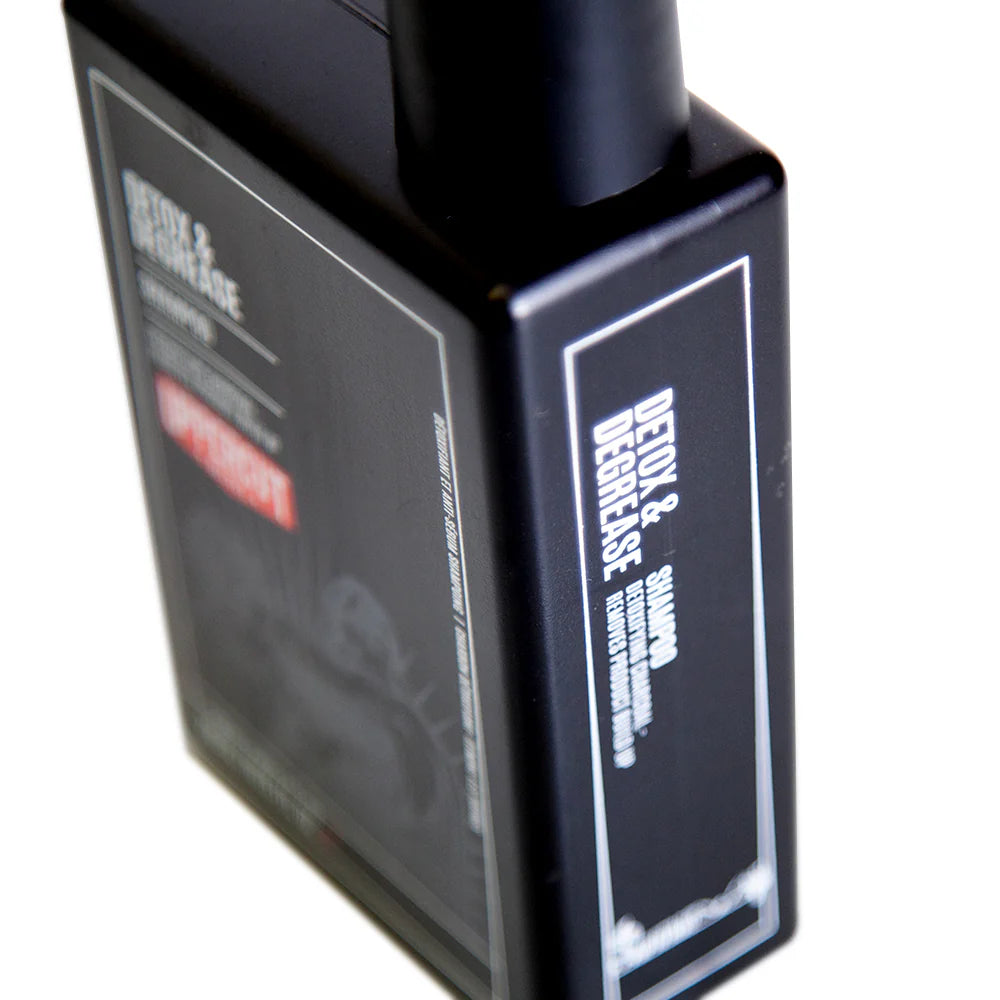Side image: Uppercut Deluxe Detox and Degrease Shampoo 240ml bottle charcoal formula packaging