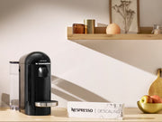 Nespresso descaling kit shown next to a compatible Krups or Magimix machine.