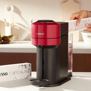 Nespresso descaling kit shown next to a compatible Krups or Magimix machine.